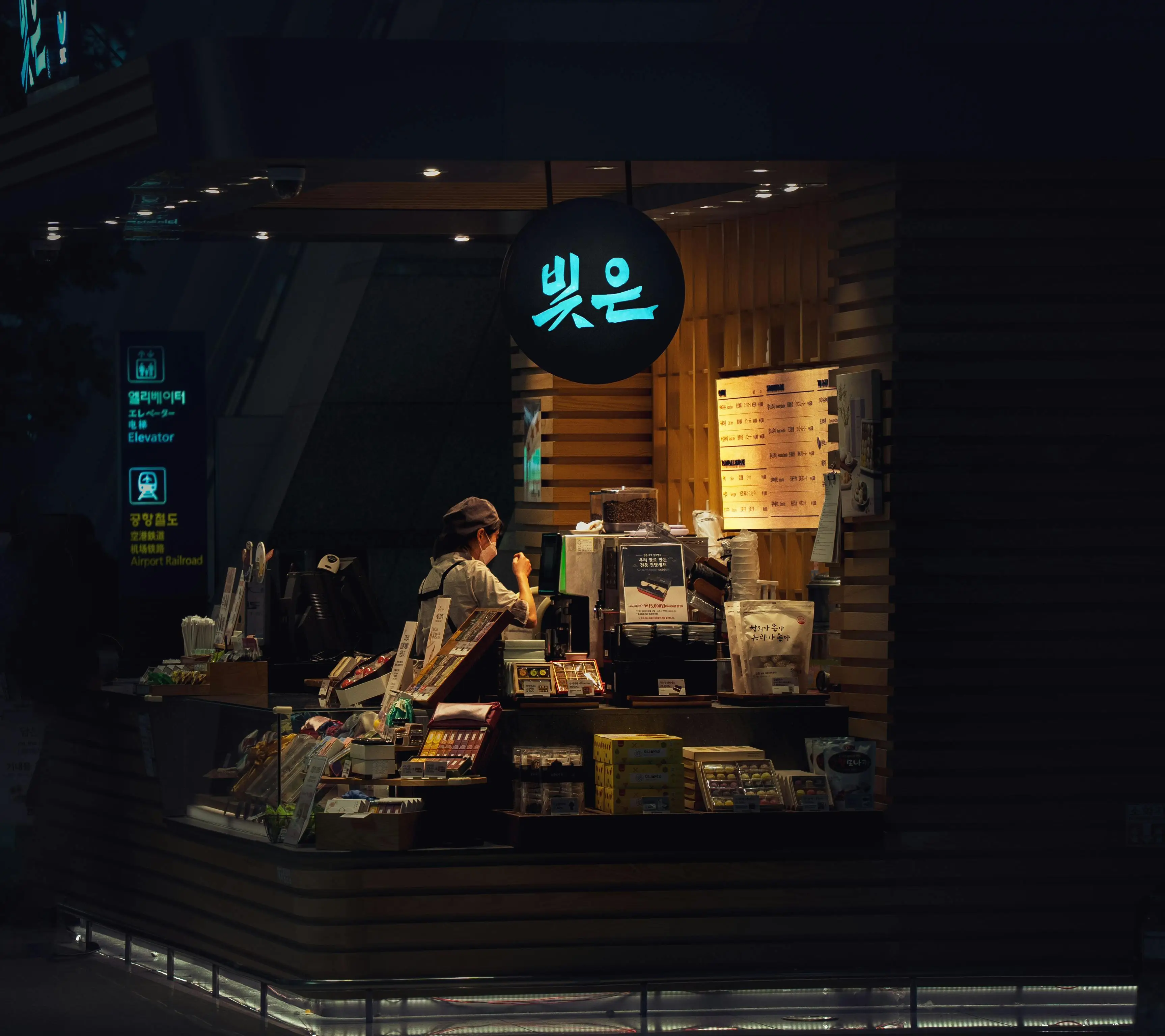Woman Working at Cafe at Night